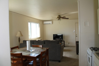 Tres Casitas dining room to living room with carpet